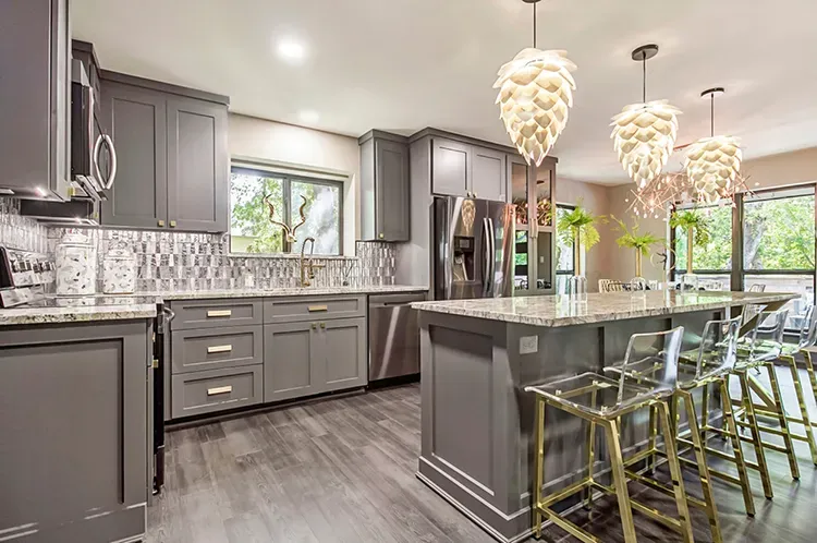 Kitchen with charcoal gray cabinets and a matching island refinished by Elegant Edge Painting.