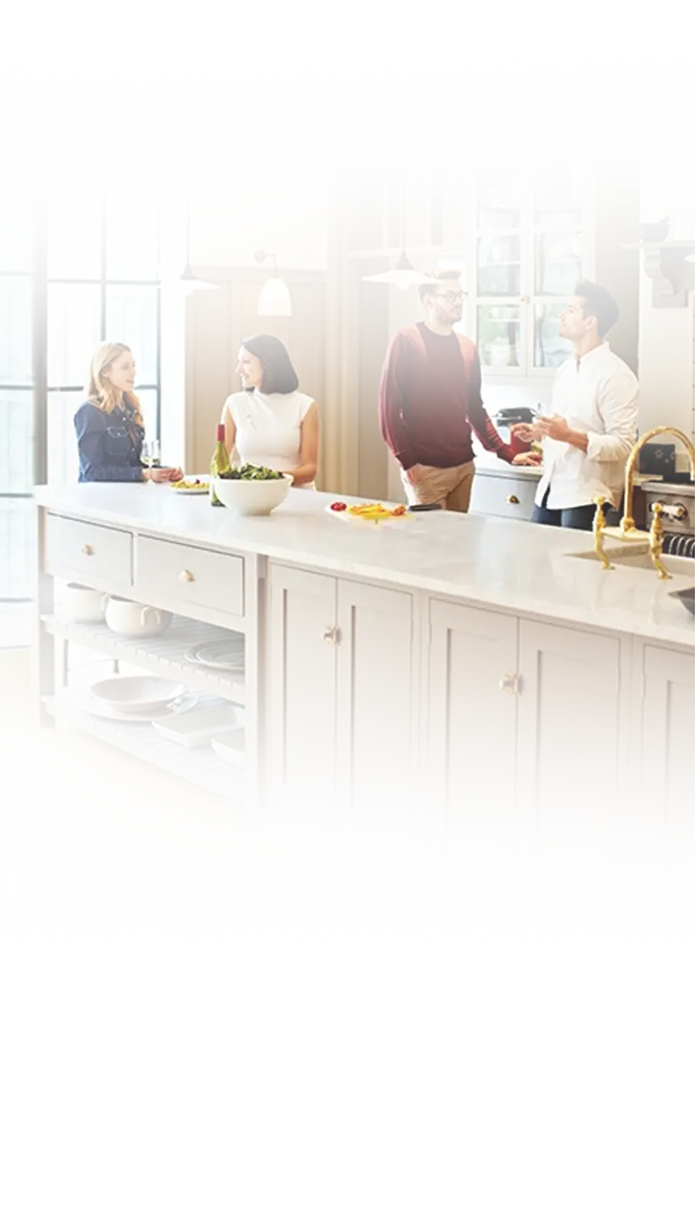 Friends gathered in a bright kitchen with freshly refinished cabinets