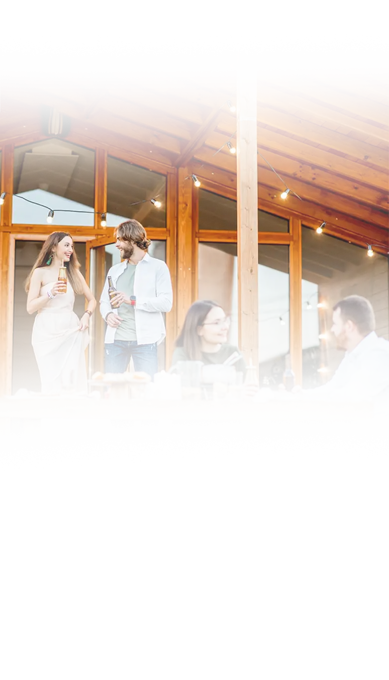 Friends enjoying a freshly stained wooden deck and cabin exterior