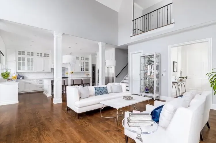 Two-story white living room open to a white kitchen after an interior repaint by Elegant Edge Painting.