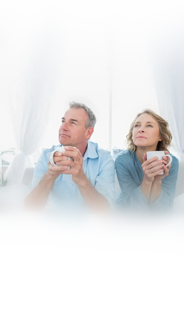 A content couple relaxing with coffee in their newly painted home