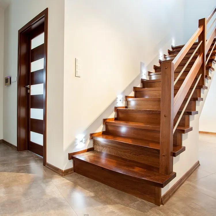 Interior staircase with rich stained wood treads and railing, with a fresh stain by Elegant Edge Painting.