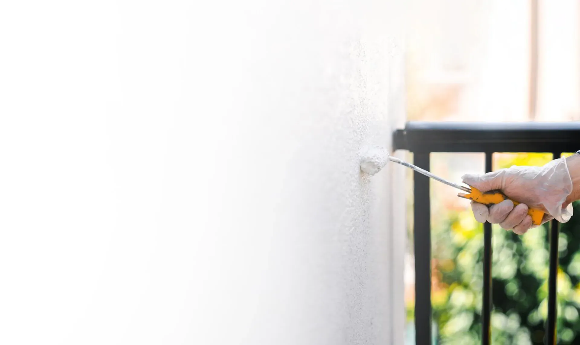 An Elegant Edge painter applying a fresh coat to a home's exterior