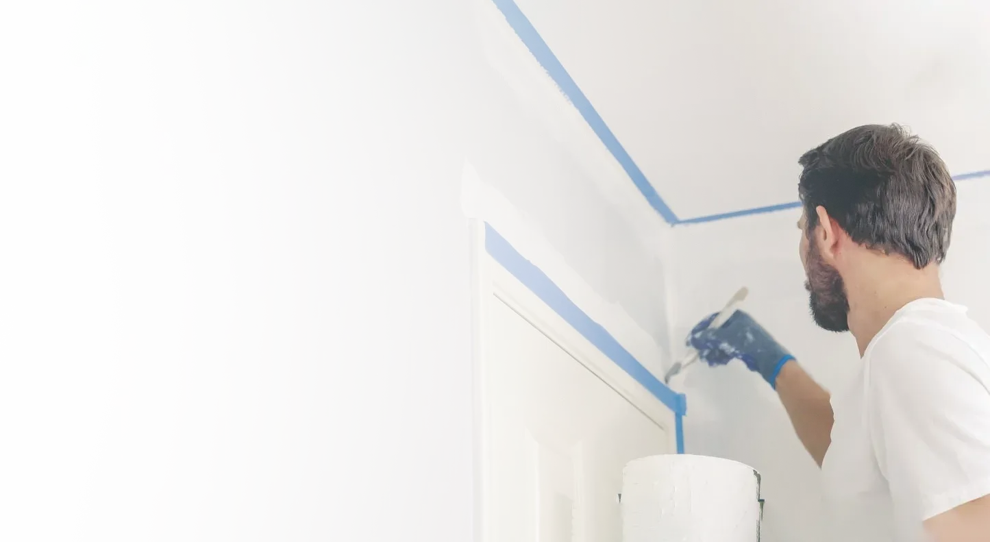 An Elegant Edge painter precisely cutting in interior trim
