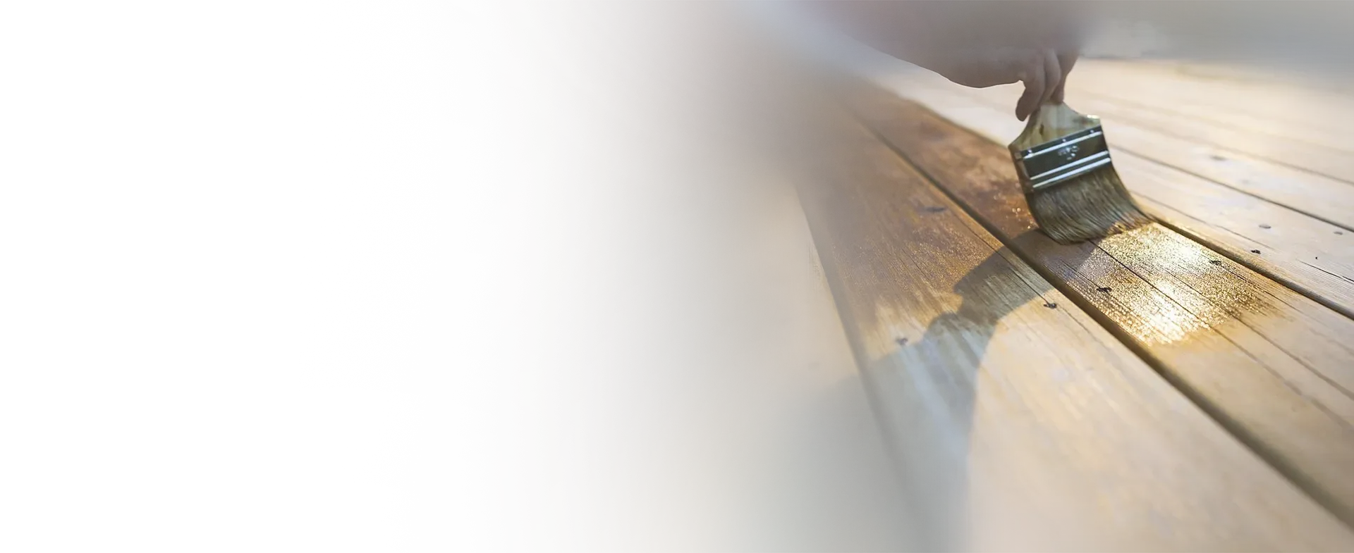 An Elegant Edge craftsman staining a wooden deck